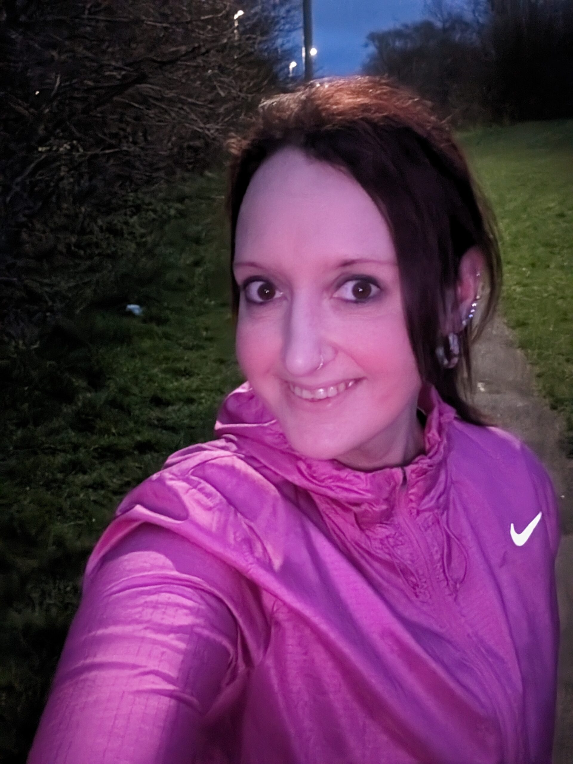 Selfie photo of a woman wearing a pink sports jacket smiling at the camera