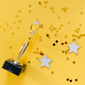 yellow background with stars and an award scattered