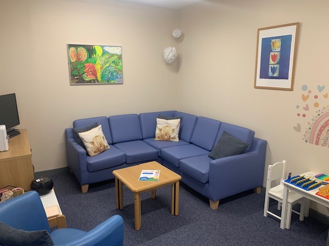 Blue sofa with cushions and a wooden coffee table